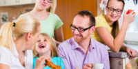 Family in kitchen having breakfast together